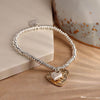 Silver plated bead bracelet with beaten gold and worn silver hearts